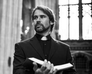 Priest holding open book