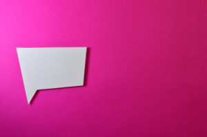 image of an empty white speech bubble against a pink background