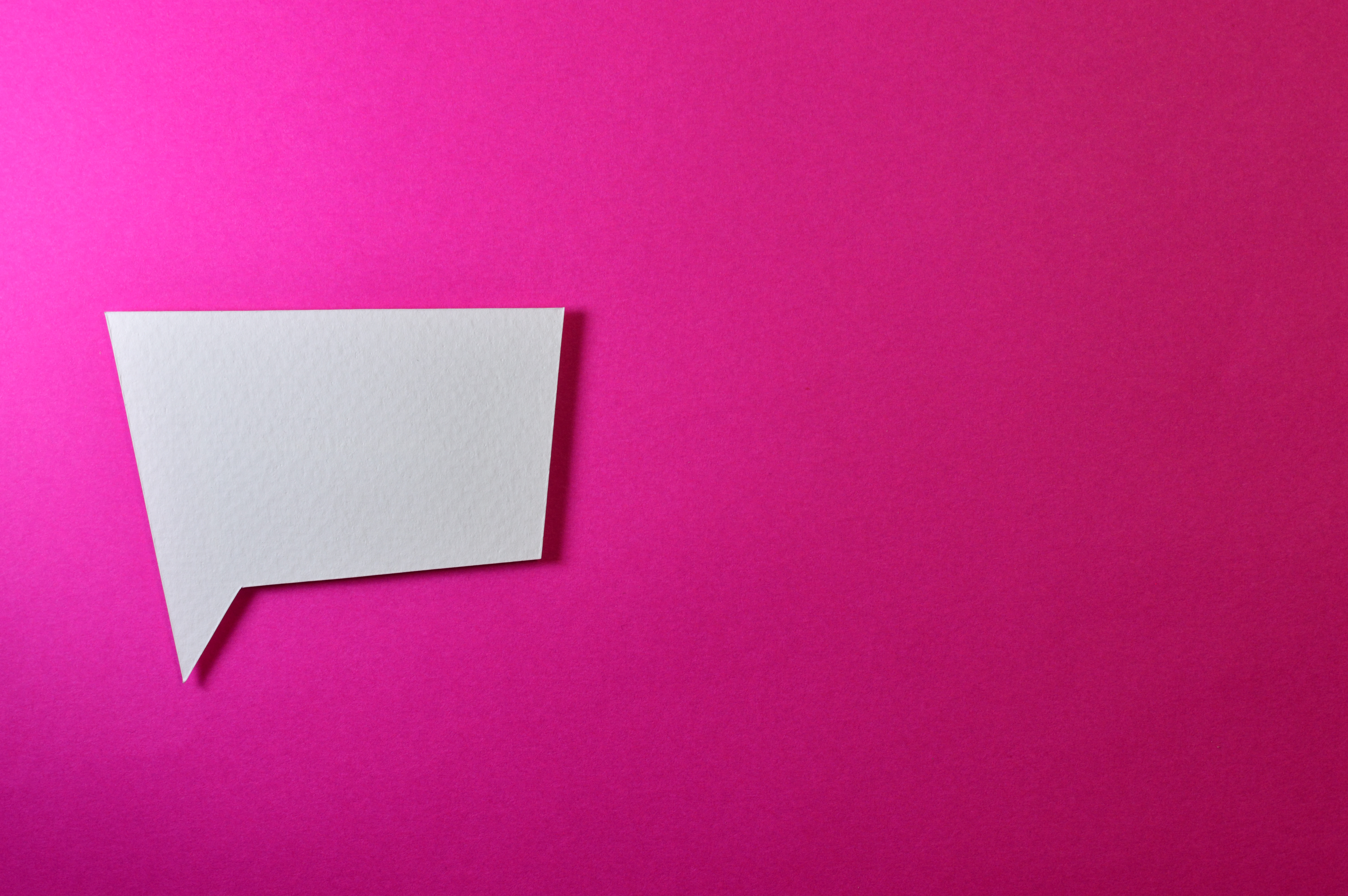 image of an empty white speech bubble against a pink background